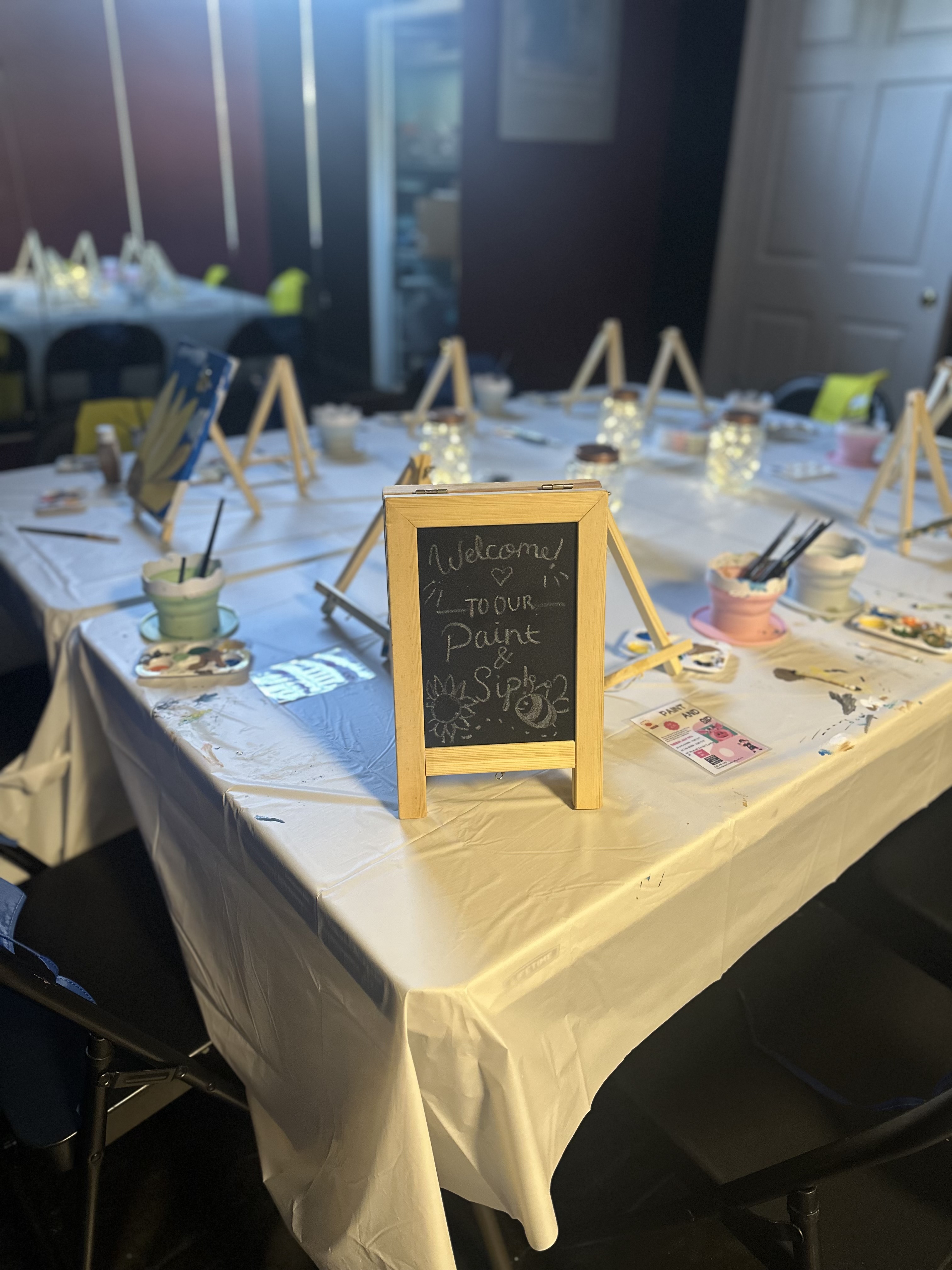 Group sitting at table painting